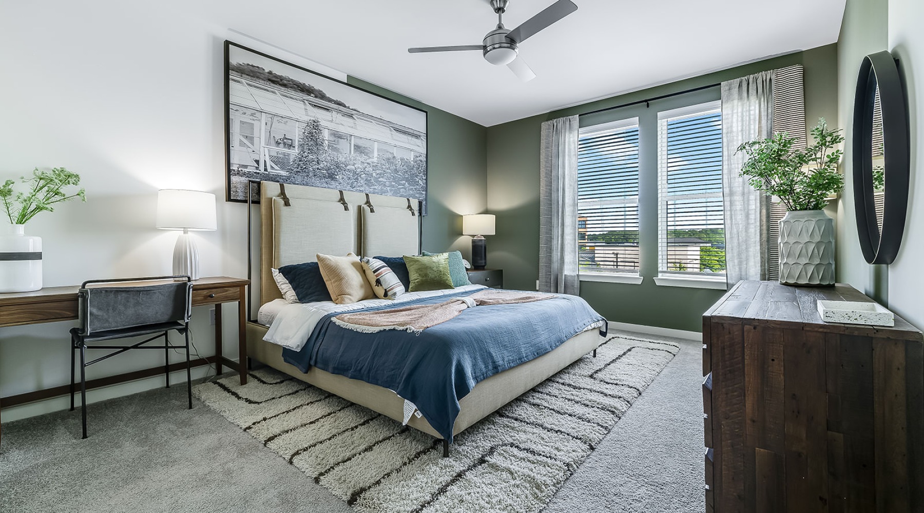 a bedroom with a bed, desk and a chair