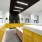elegant, well lit mail room with yellow mailboxes