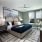 accent colored walls in large bedroom with windows overlooking the neighborhood
