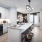 open kitchen with seating at island and overhead lighting