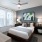 large windows brighten carpeted bedroom with ceiling fan and light fixture