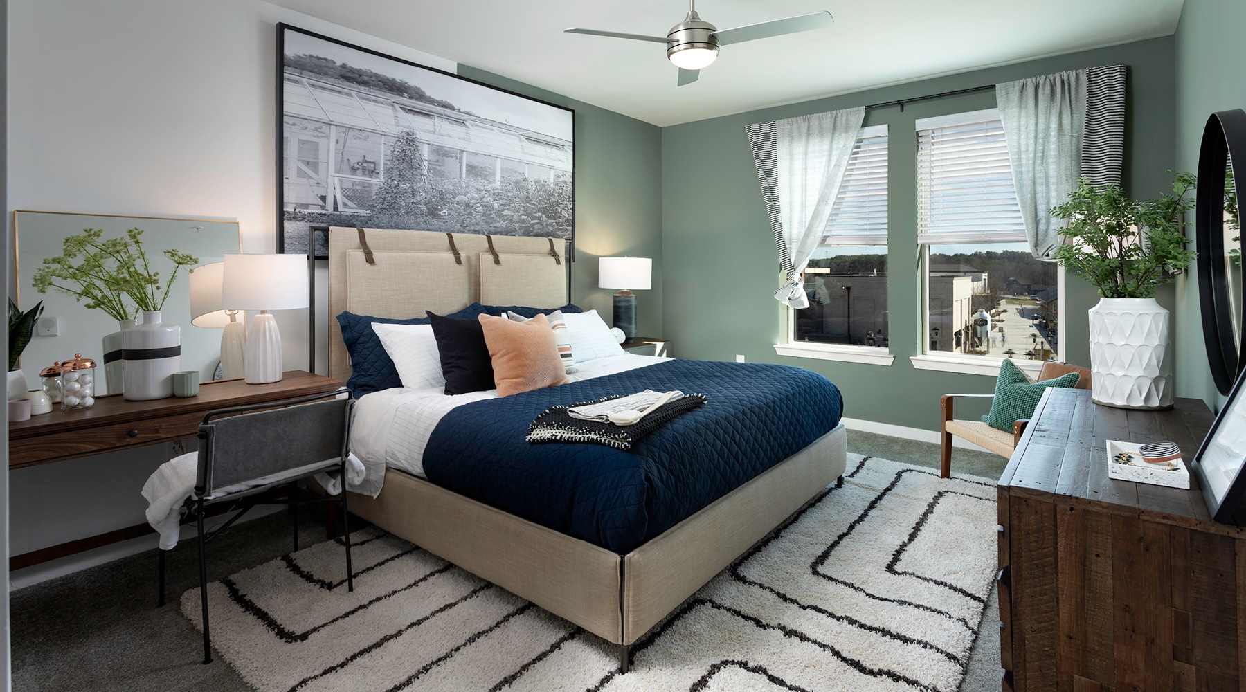Welcome to Halcyon accent colored walls in large bedroom with windows overlooking the neighborhood